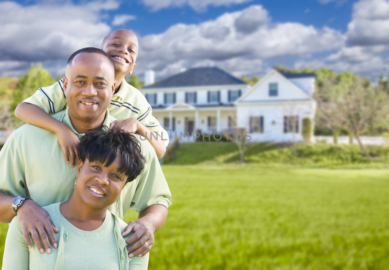 African American Family In Front of Beautiful House by Feverpitched