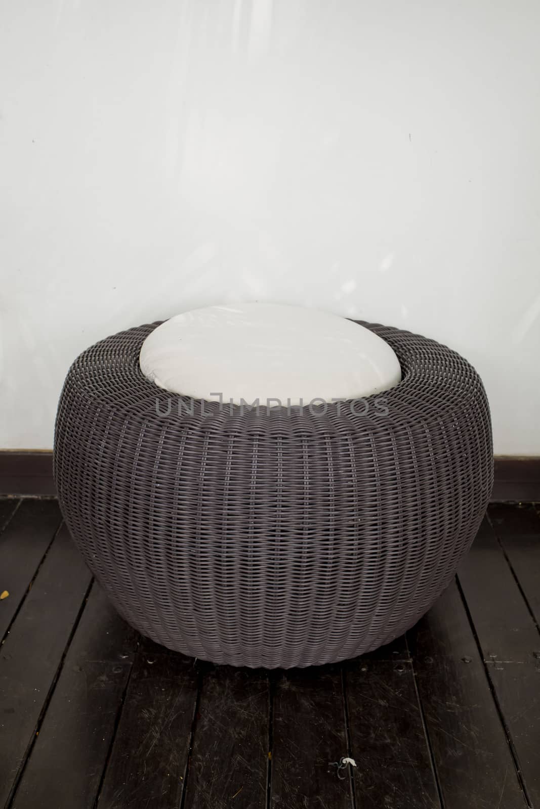 A modern design of rattan stool with white cushion