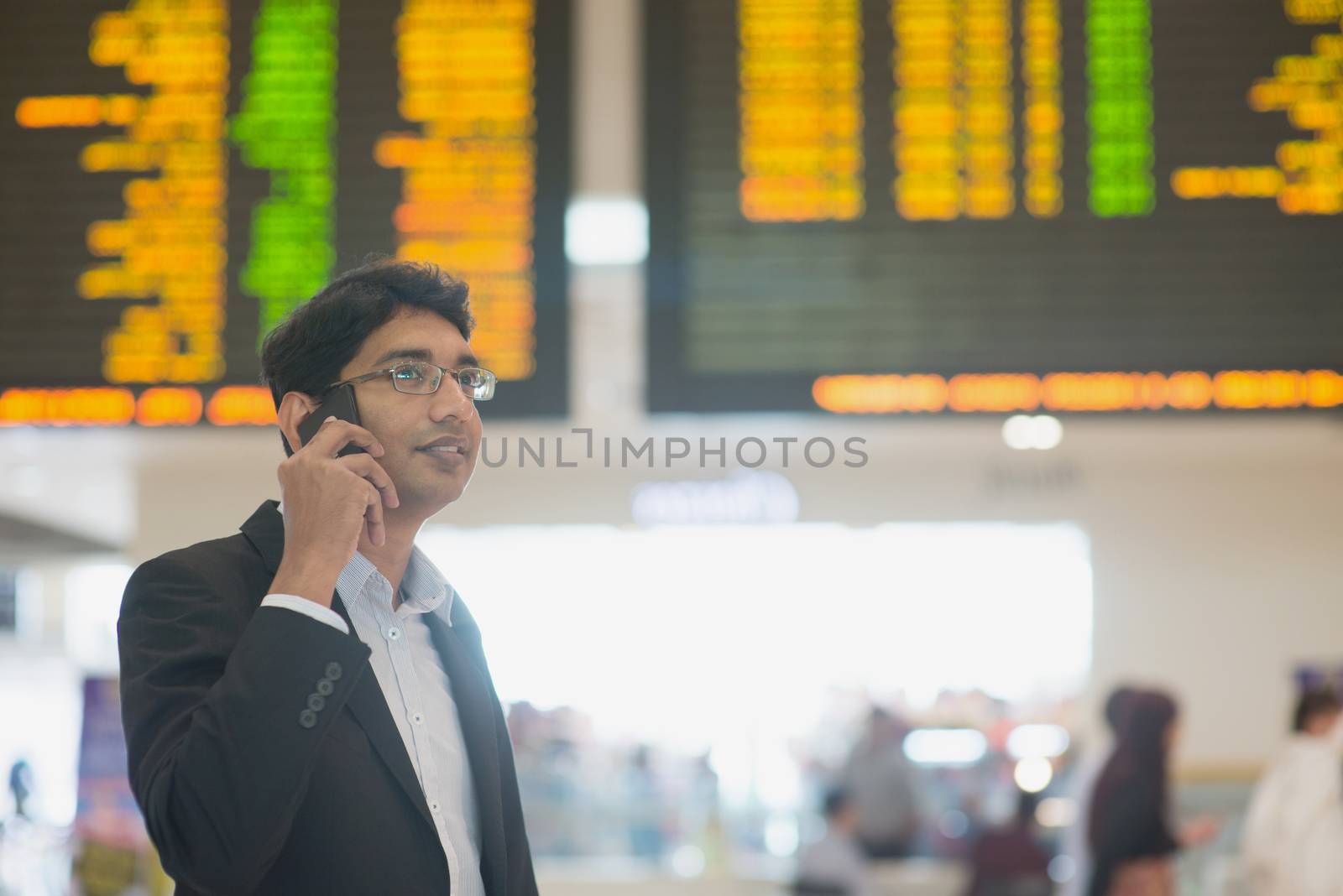 Asian Businessman on the phone during his business travel, at the airport .