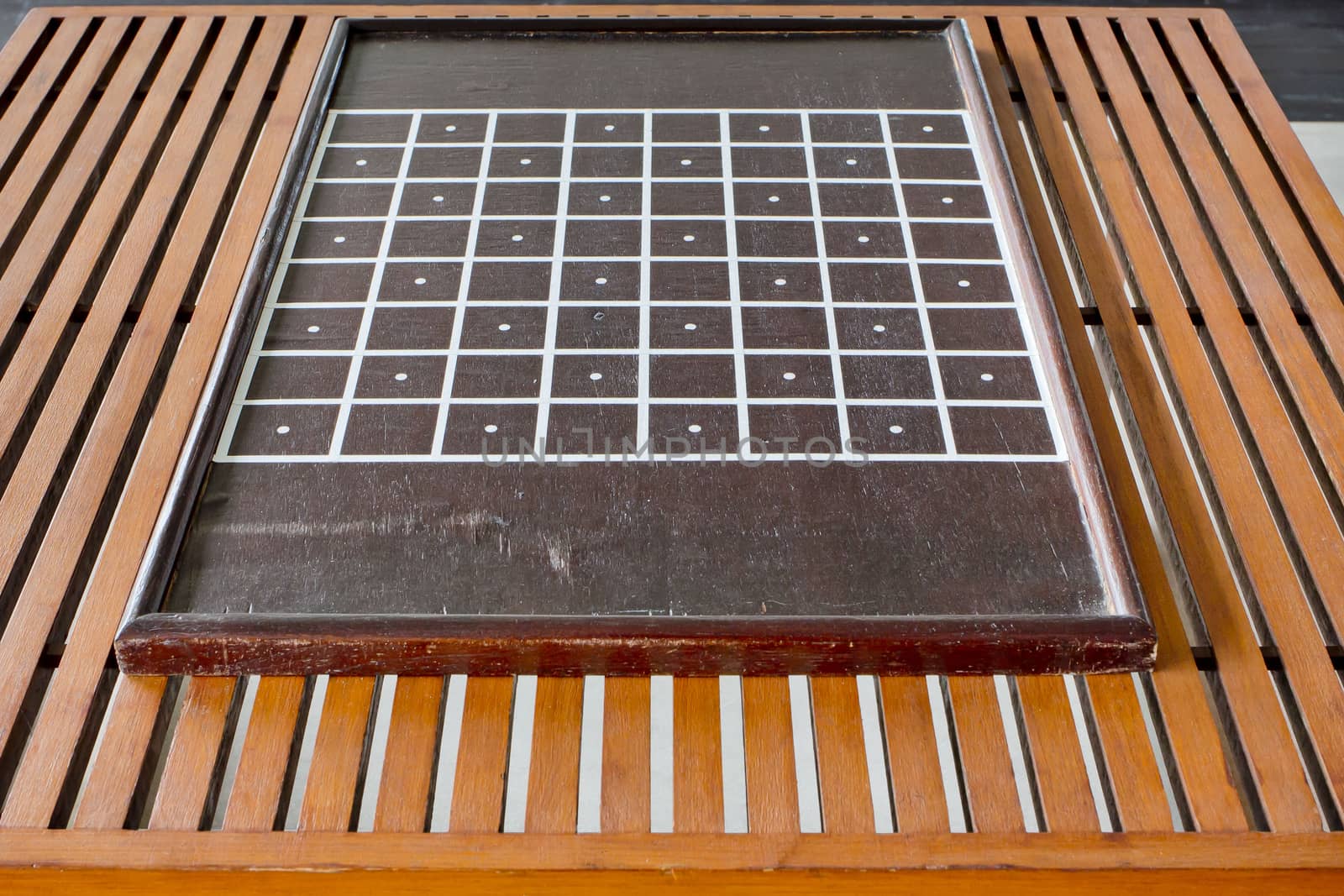 Chessboard on wooden table.