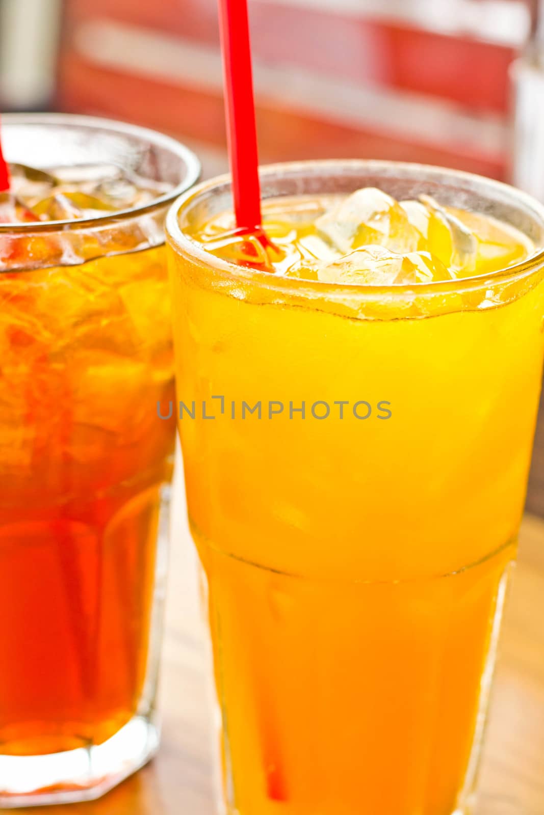 Orange juice with ice  in a glass place on the table  by Thanamat