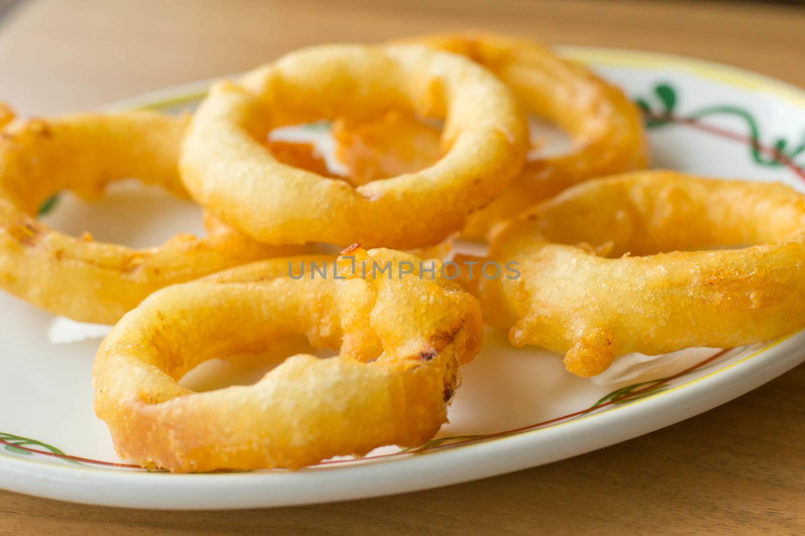 onion rings and dip sauce on the plate  by Thanamat