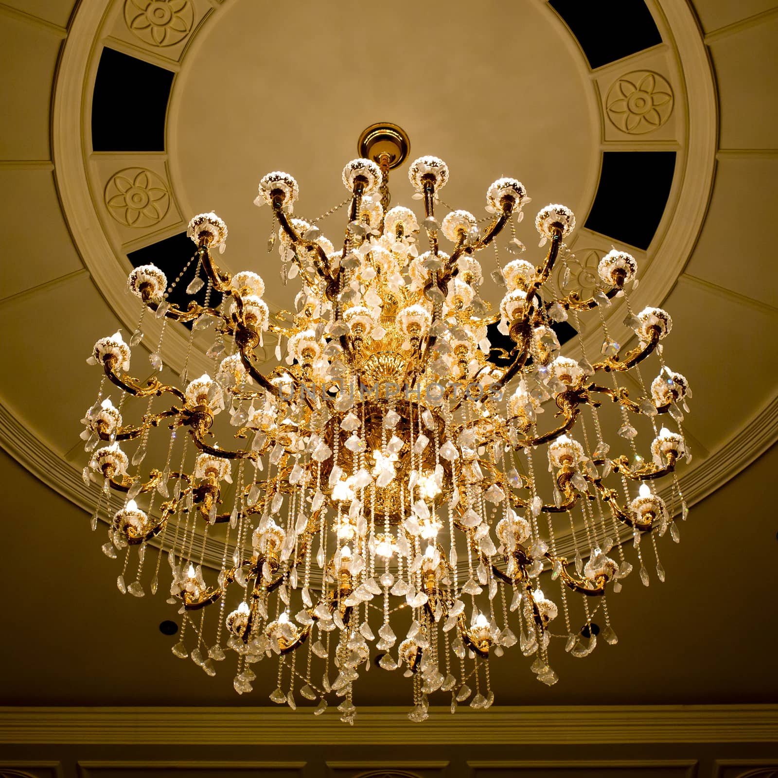 classical crystal chandelier hanging on beautiful ceiling