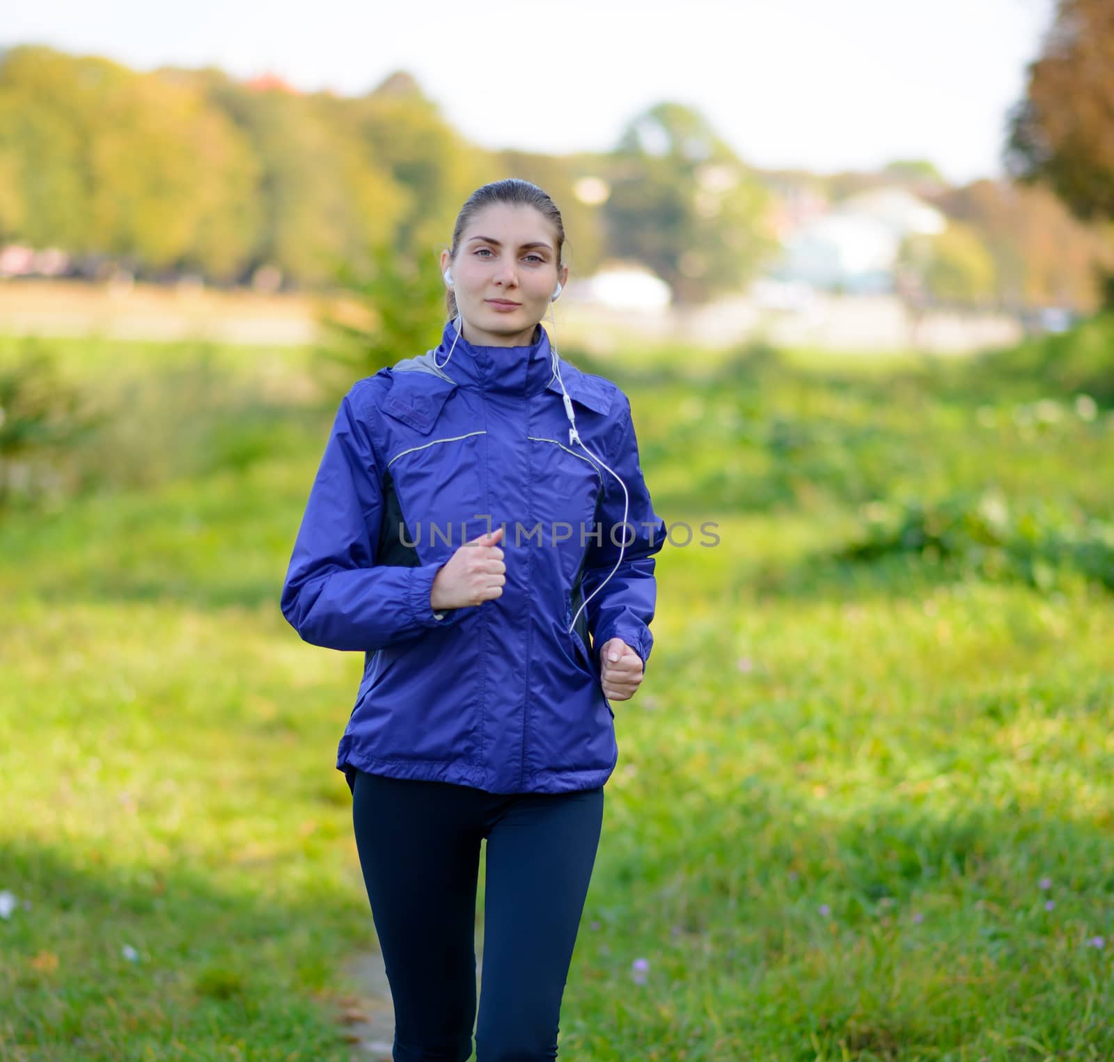 Young Beautiful Woman Running in the Park by maxpro