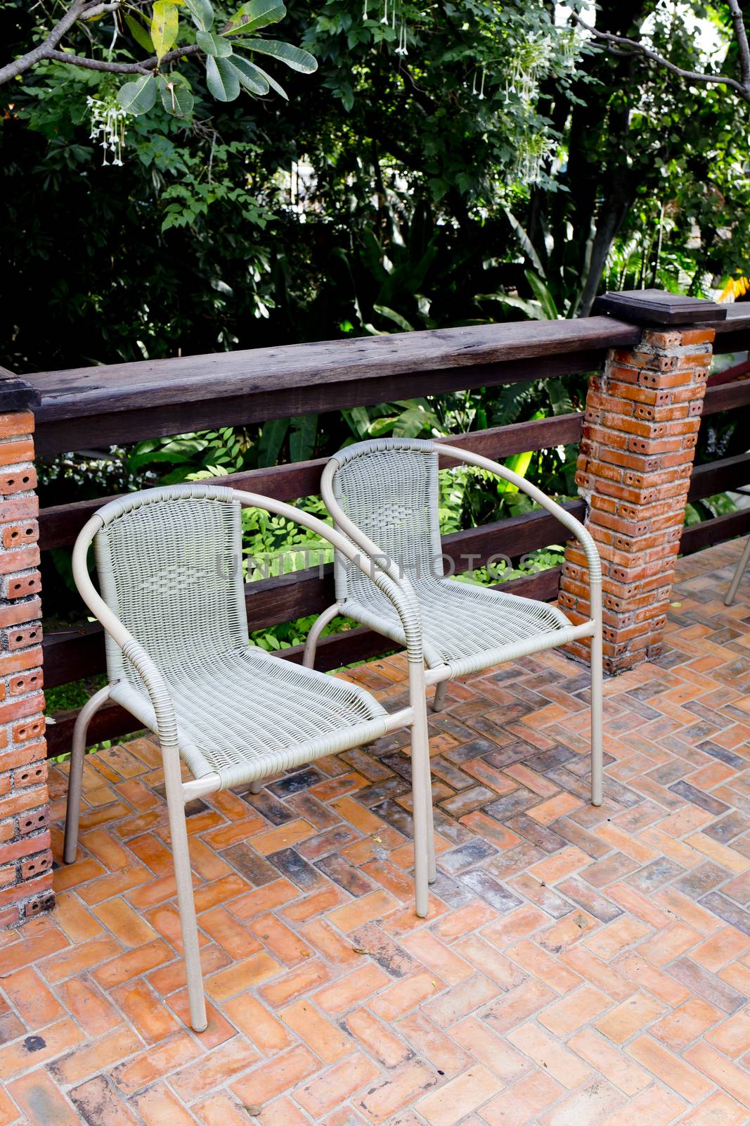 Out door couple of rattan chairs.