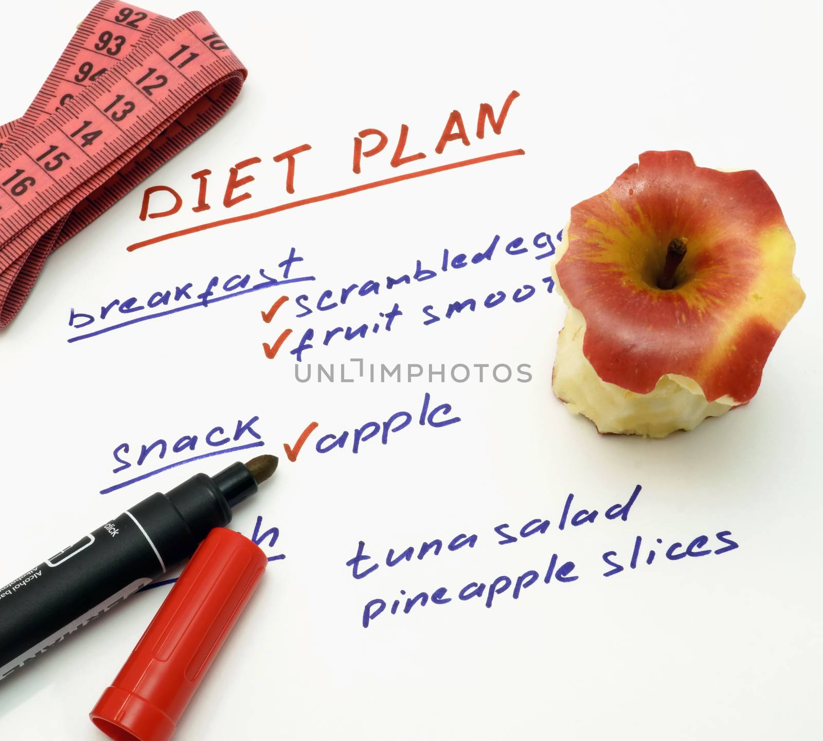 Diet plan with apple, marker and measuring tape