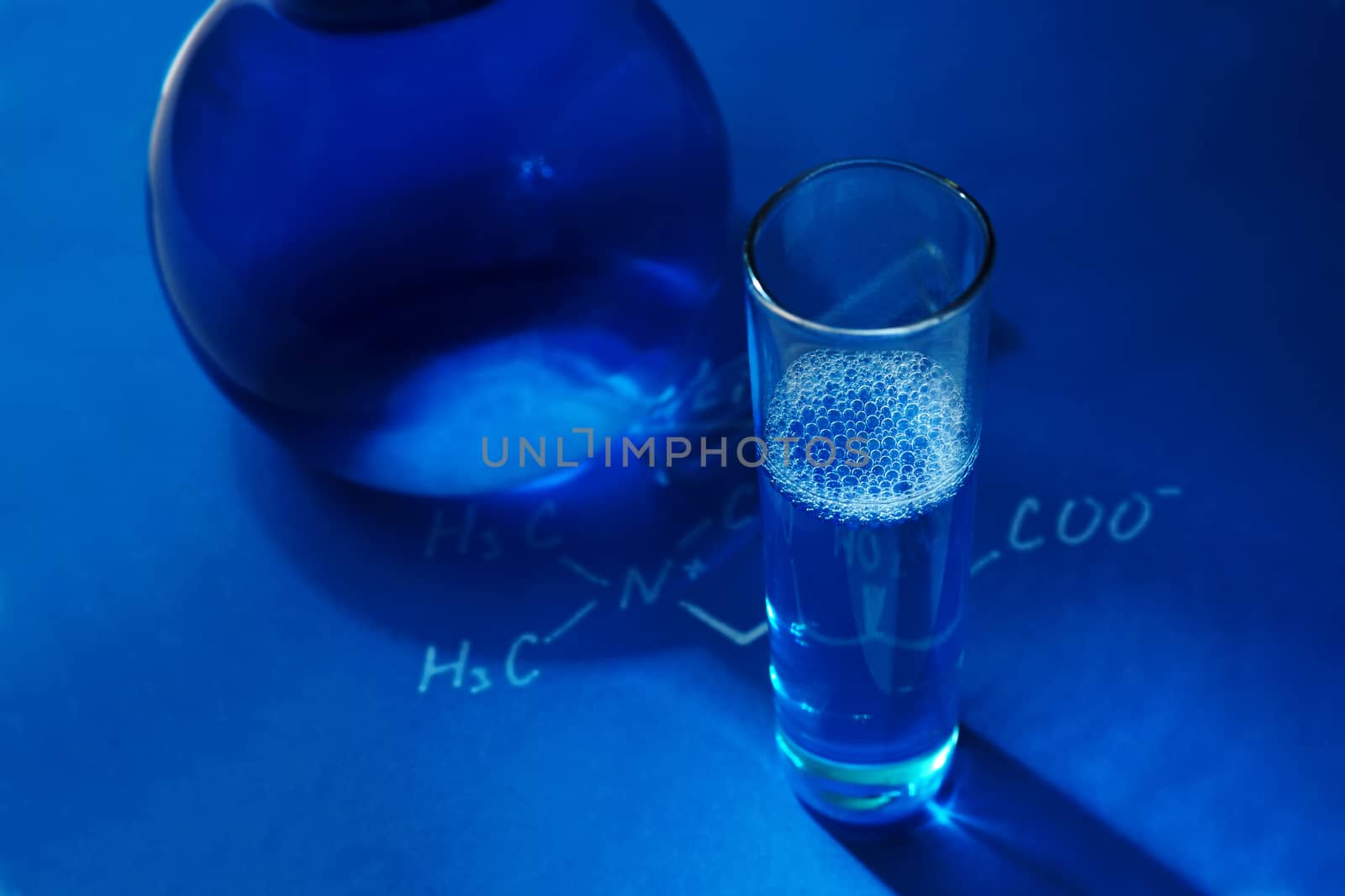 Laboratory glassware on blue background. Chemistry - concept photo
