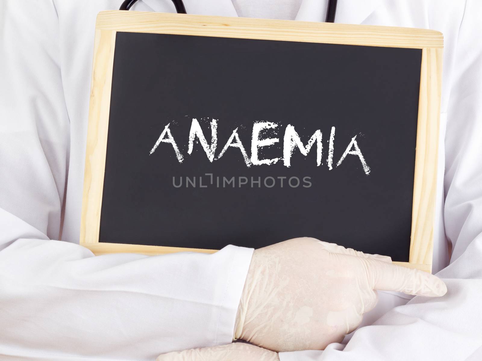 Doctor shows information on blackboard: anaemia by gwolters