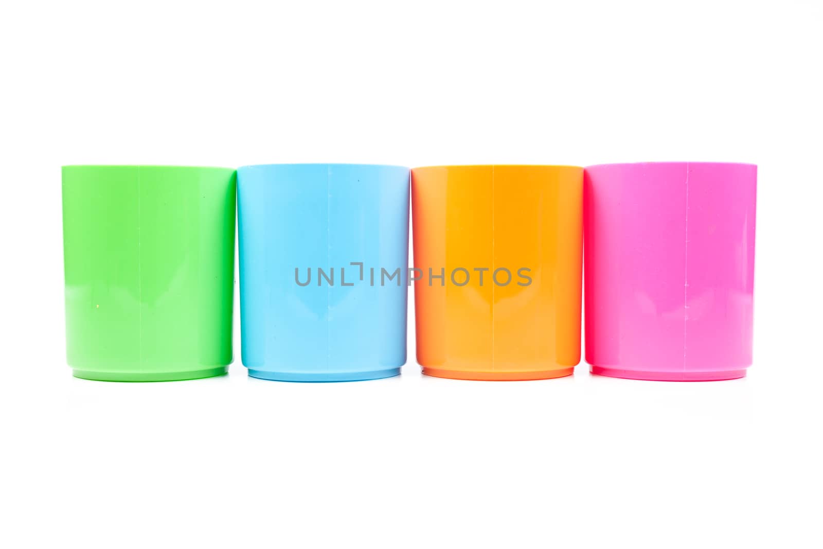 plastic cups colors. Colorful glass arranged in rows. Isolated white background