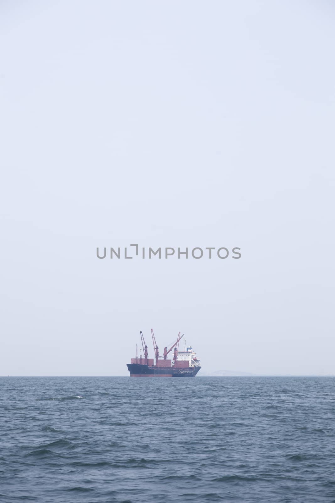 Large cargo ship Boats moored in the sea to make sense compared to the coast.