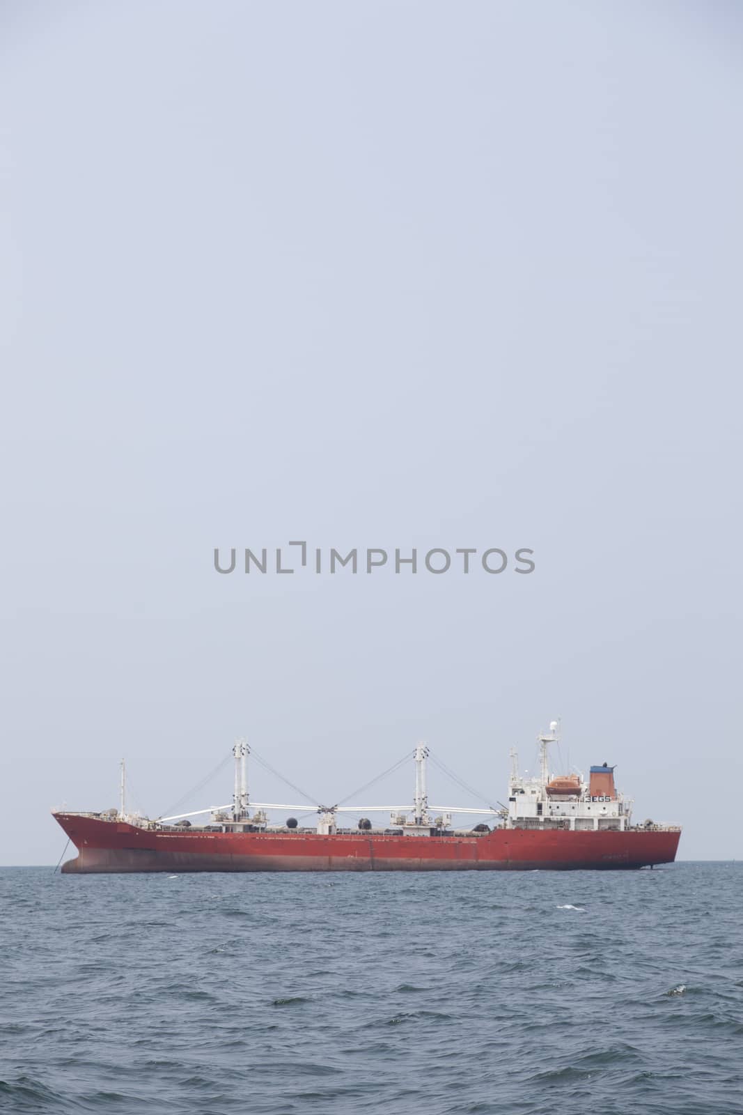 Large cargo ship Boats moored in the sea to make sense compared to the coast.