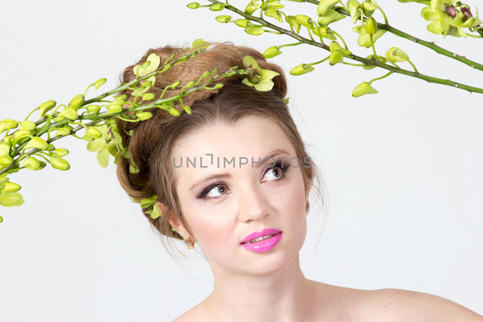 Beautiful woman with orchid flower in hair posing by gsdonlin