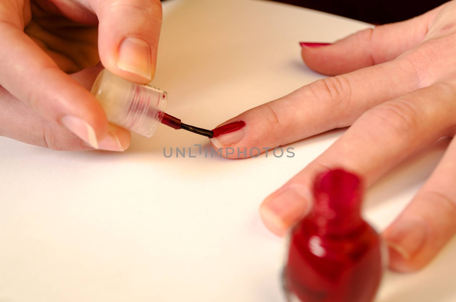 In beauty salon.Toes with red nail polish.