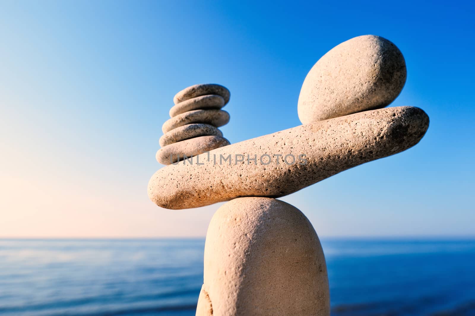 Balancing of white pebbles on the top of stone