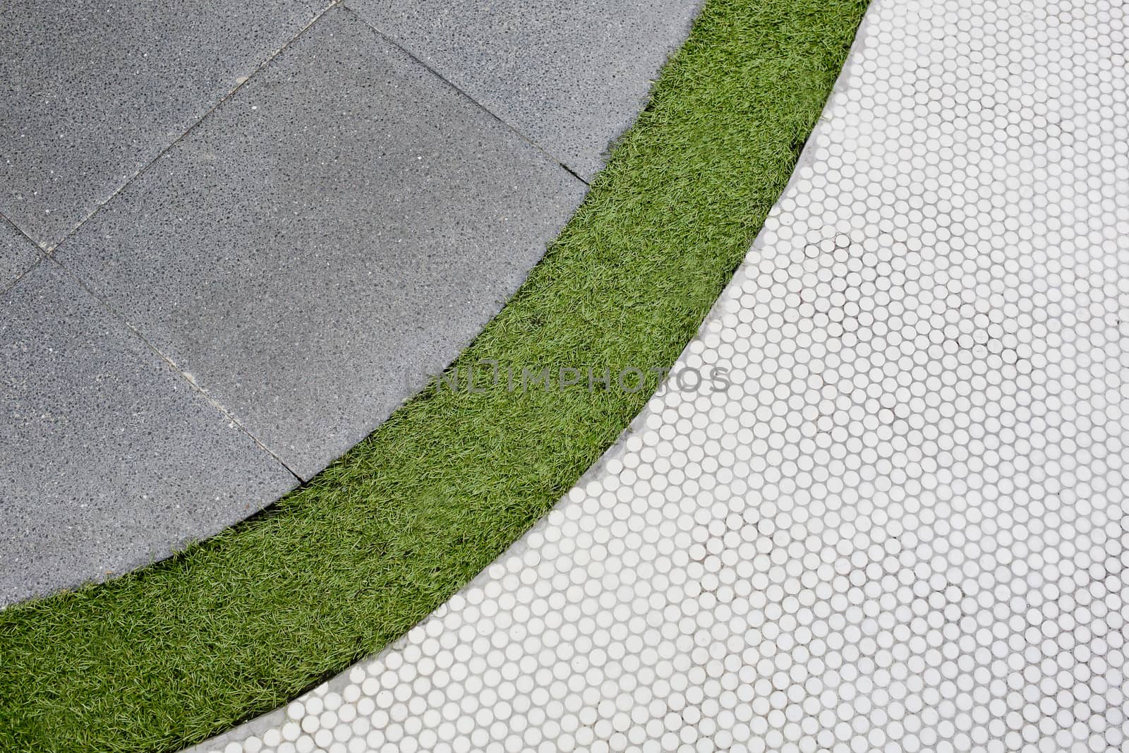 Walking foot path with green grass and tiles background texture