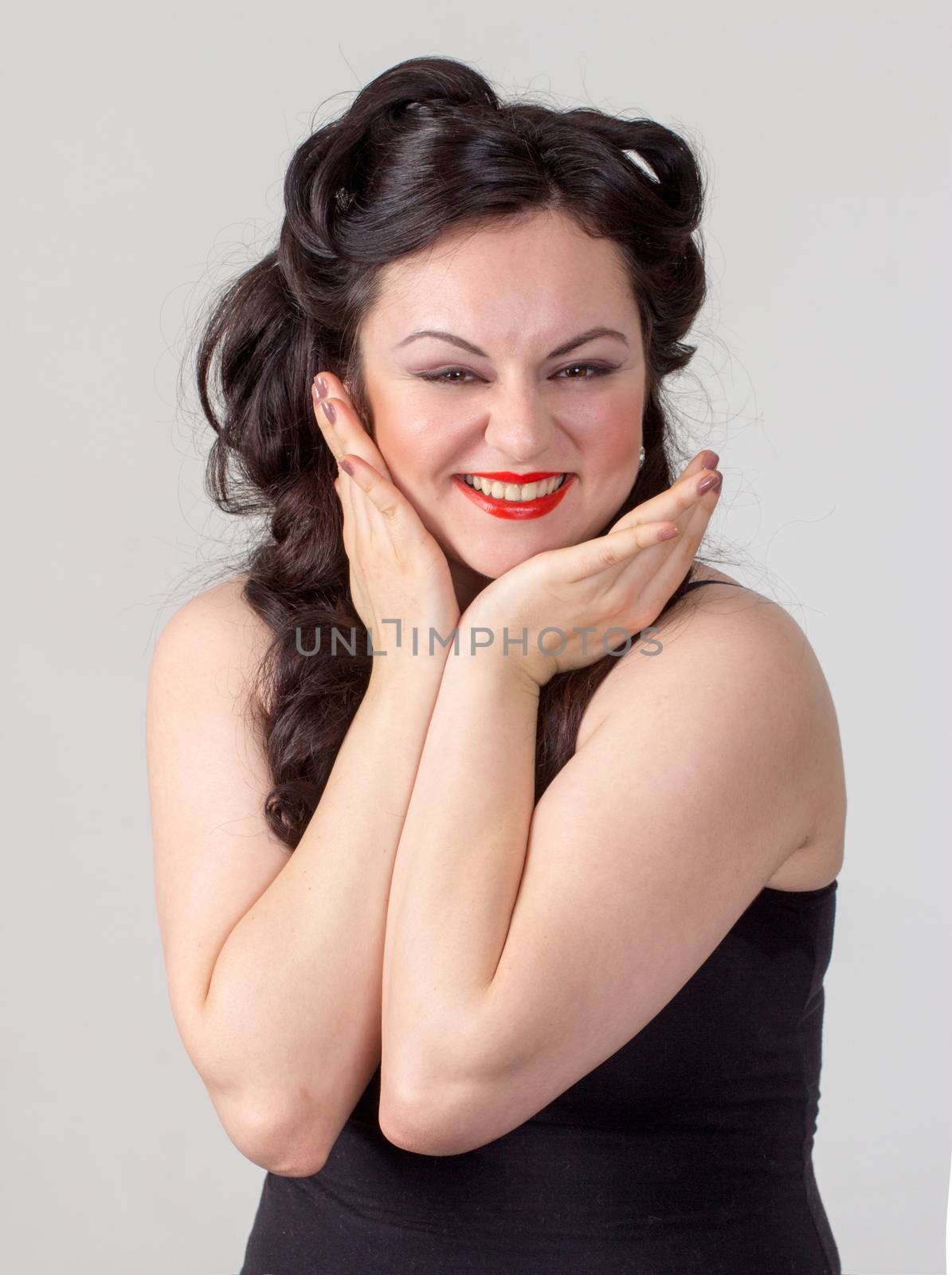 Pretty brunette girl posing like Marilyn Monroe with red lips