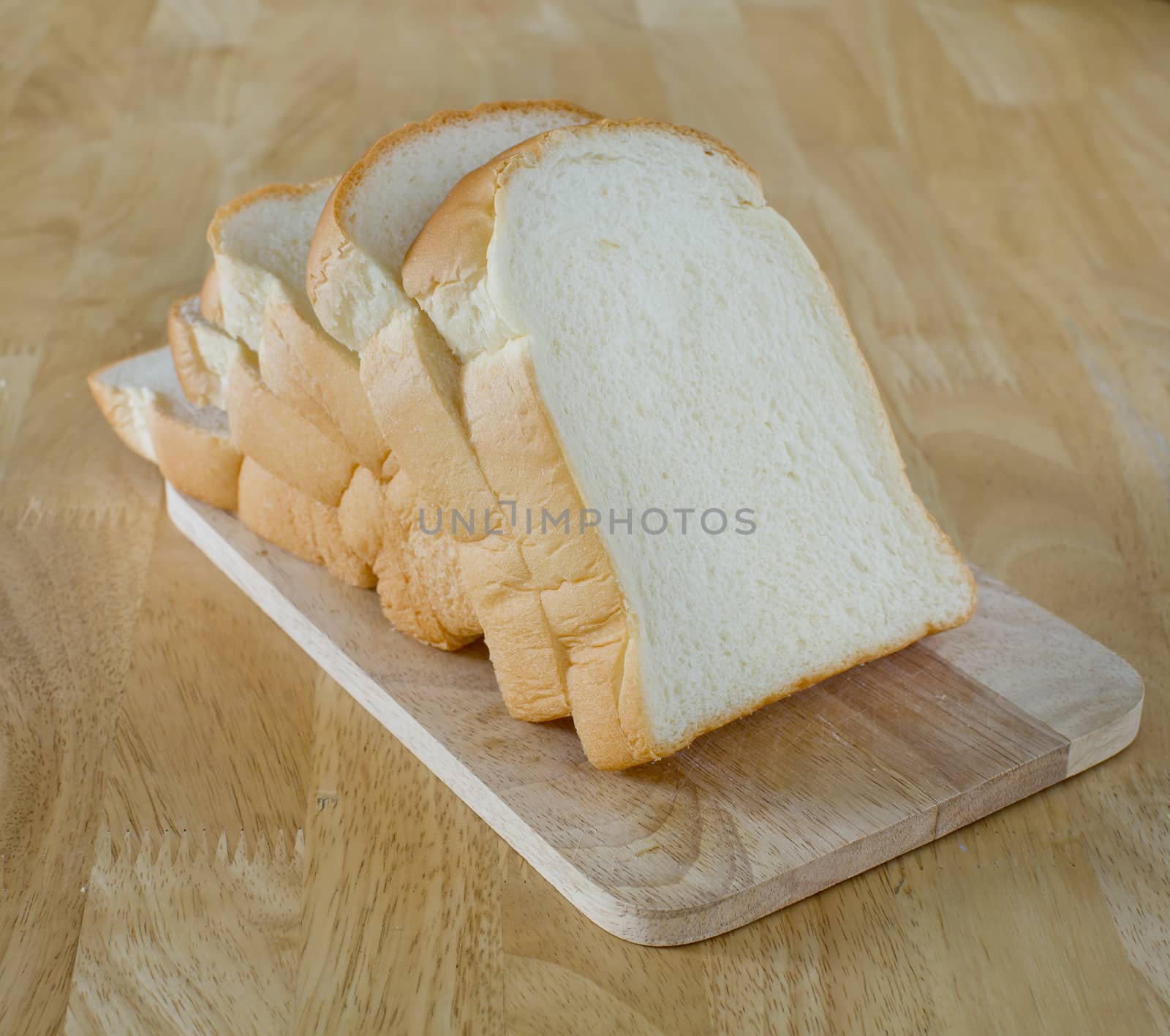 Slide bread on wooden cutting board