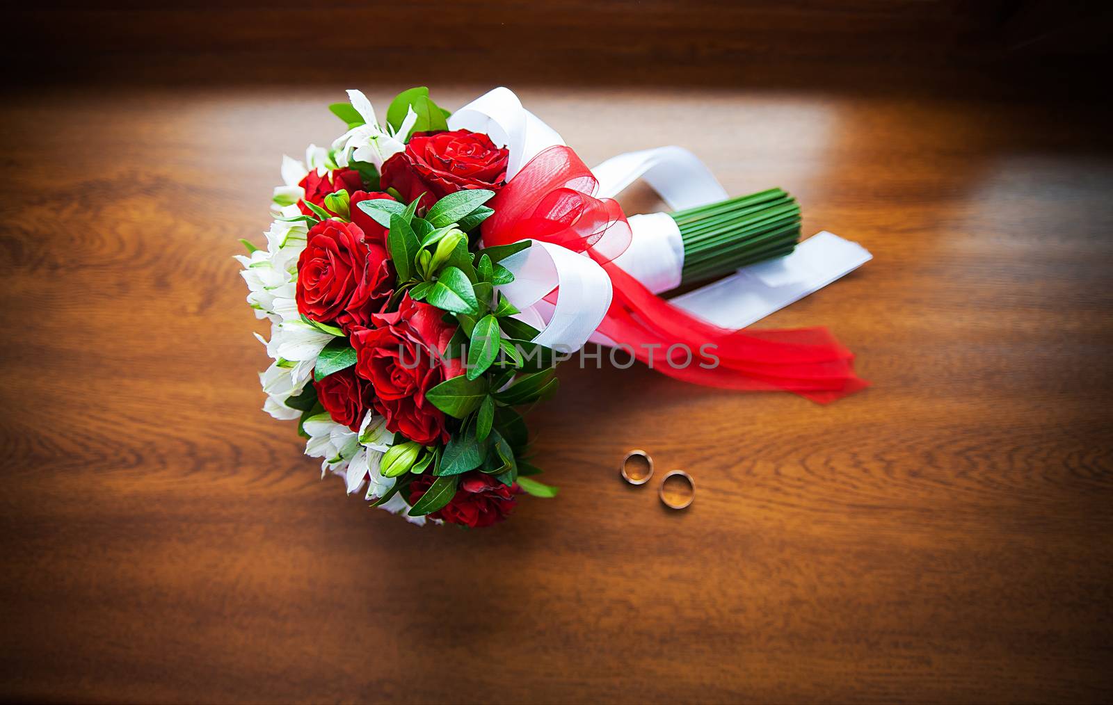 Beautiful wedding bouquet and rings on wood by sfinks