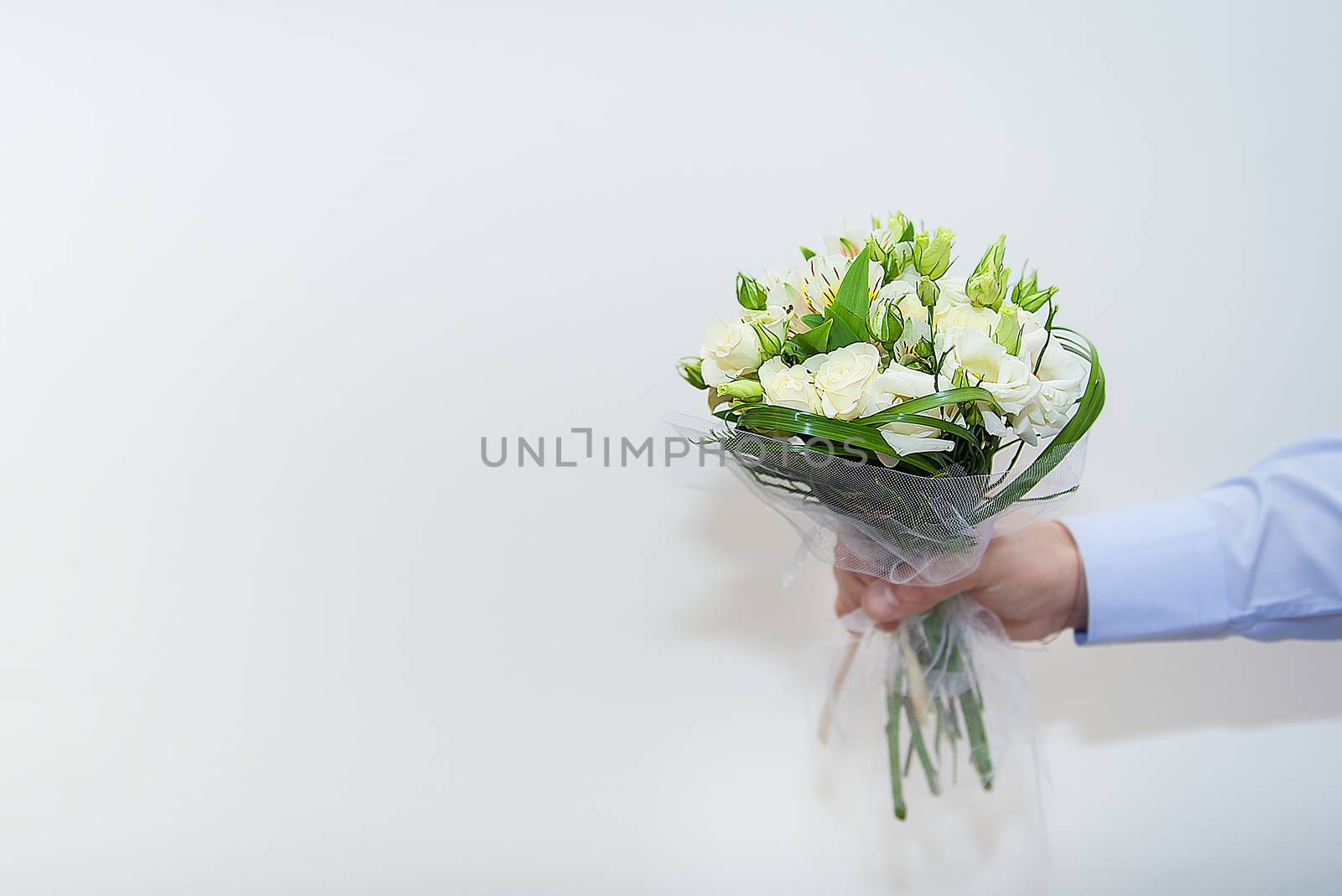wedding bouquet in a hand of the groom on white background.
