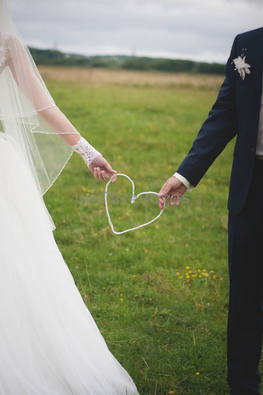 Bride and groom outdoor portrait with white heart by sfinks