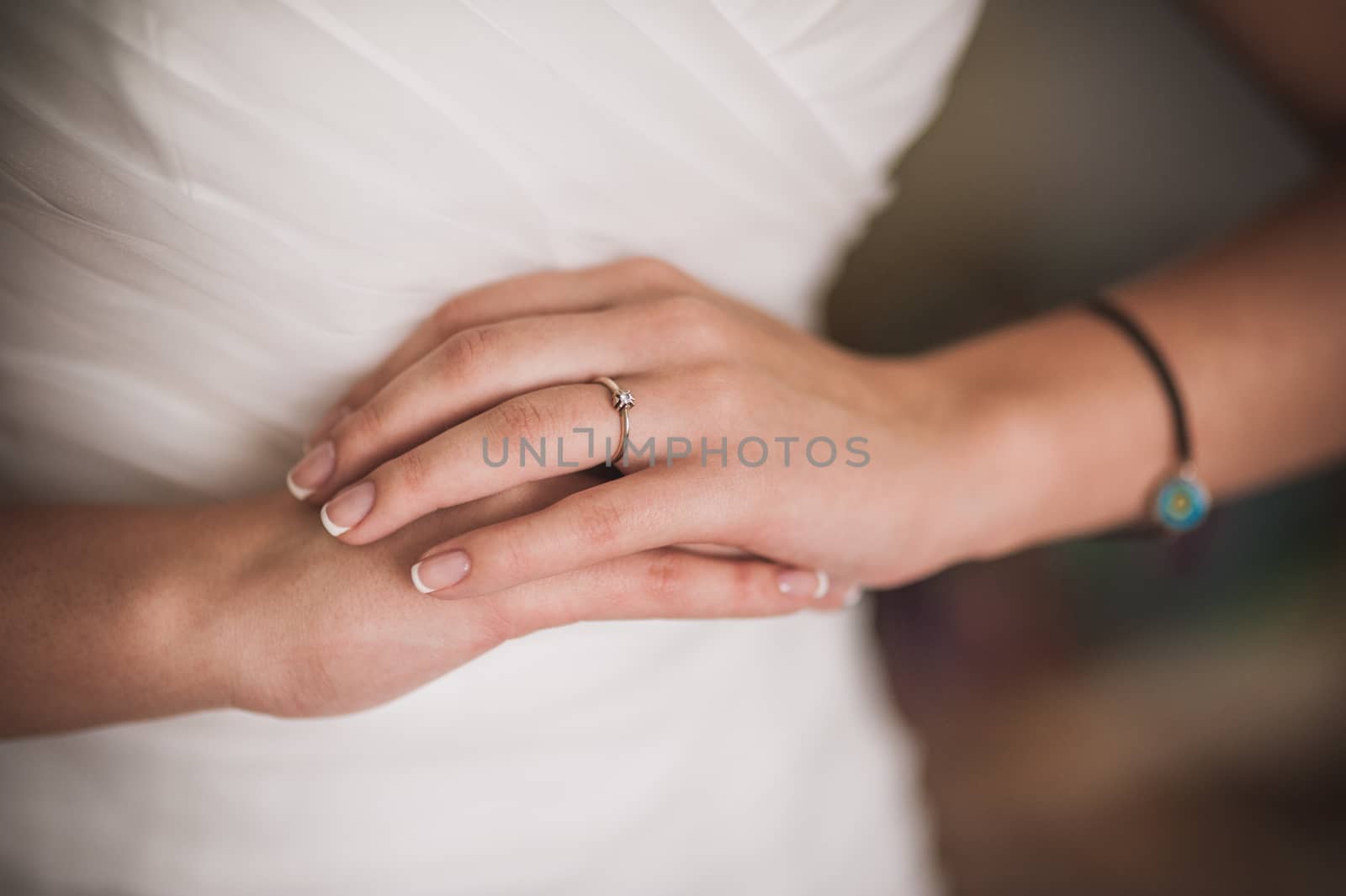 hands of bride with wedding ring on 