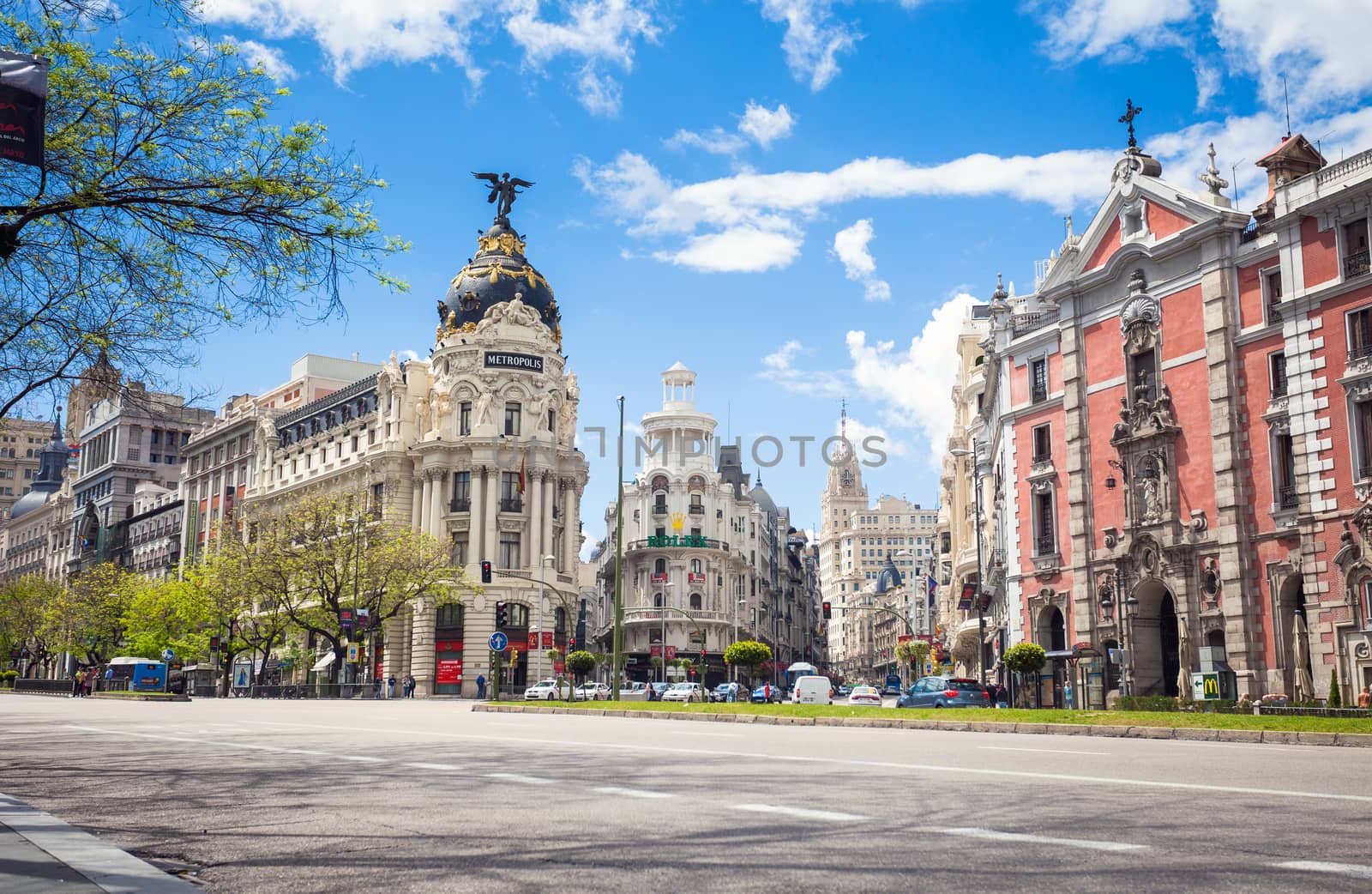 Madrid, Spain - May 6, 2012: Metropolis Building (Edificio Metropolis) and Grassy Building (Edificio Grassy) famous Beaux-Arts style of Madrid and San Jose church, Spain