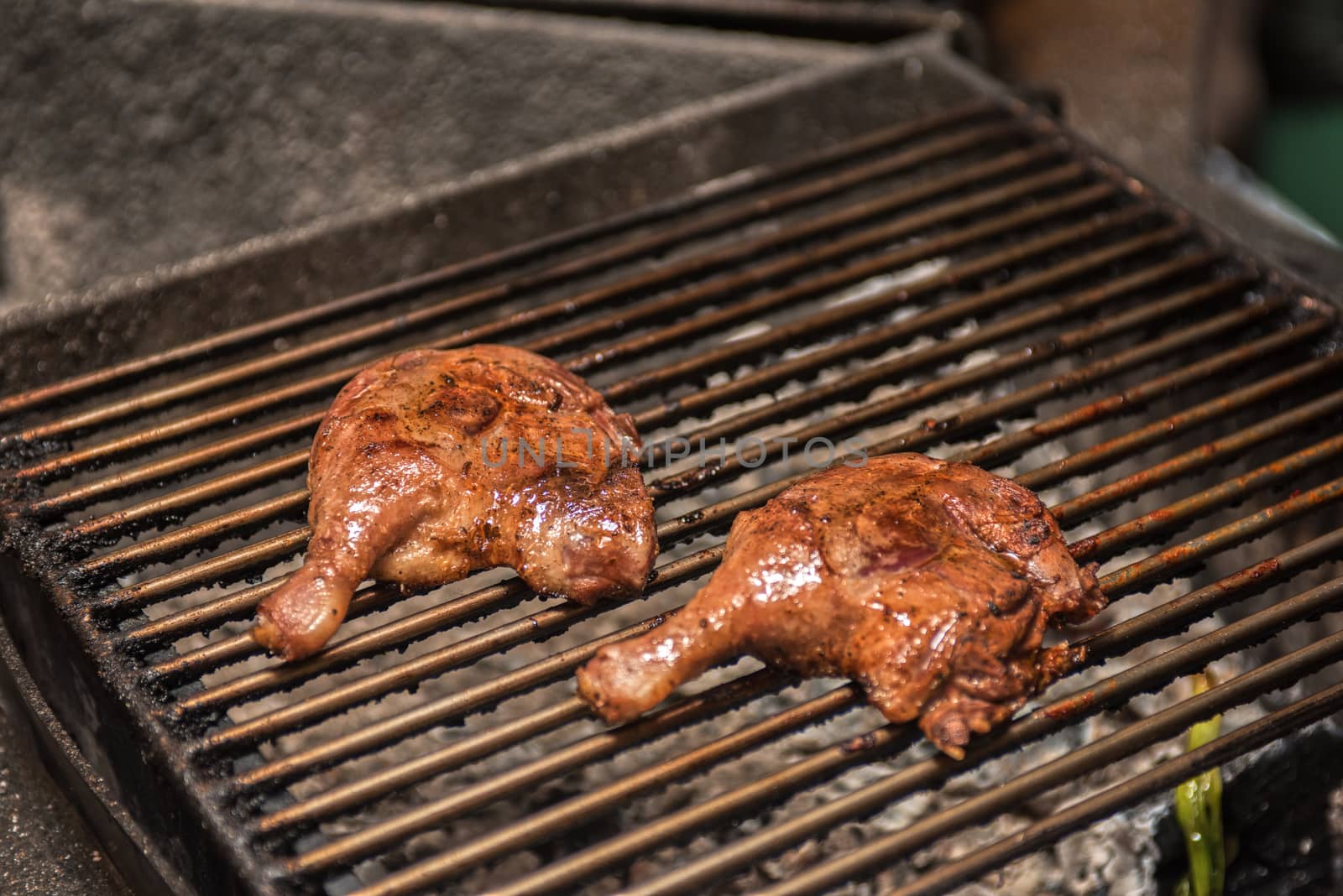 fillet of duck legs on a grill preparing 
