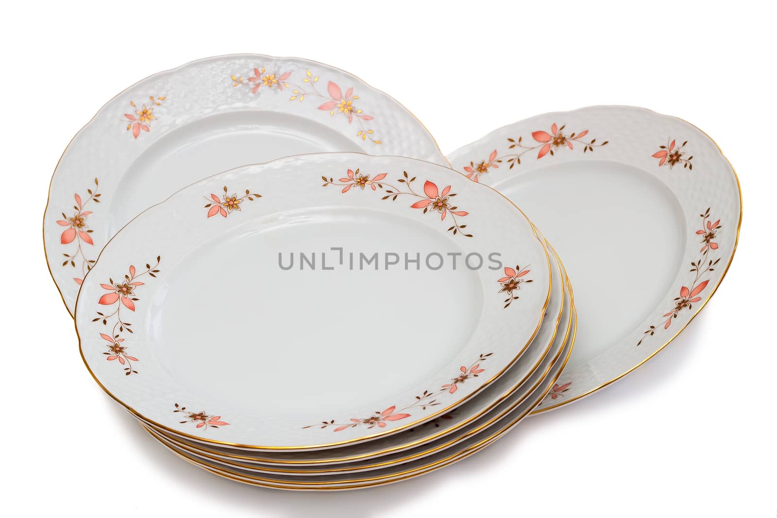 White plates with delicate ornamentation. Presented on a white background.