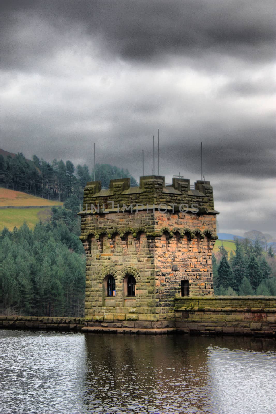 derwent reservoir dam breakwater under a cloudy sky by chrisga