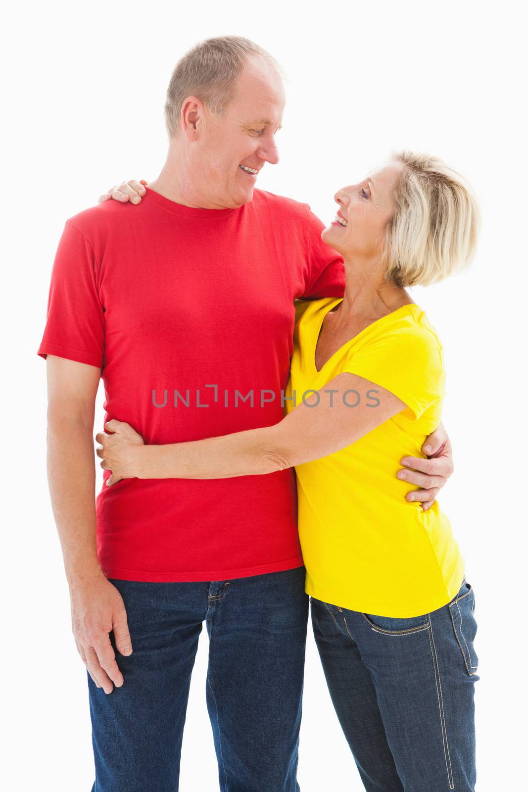 Happy mature couple hugging and smiling on white background