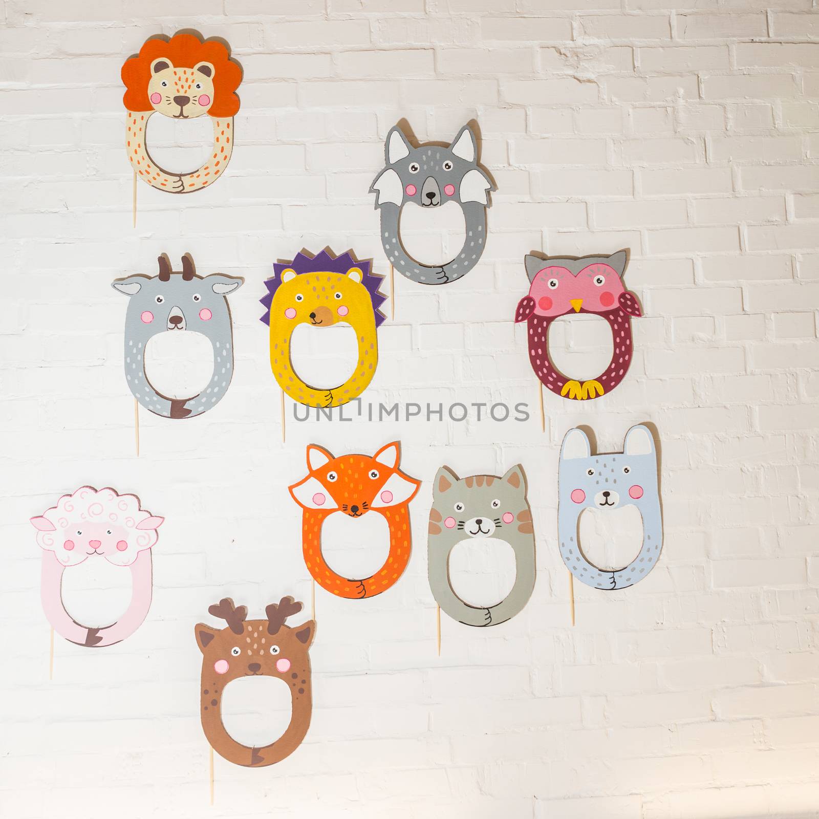 Set of cardboard masks on a white brick wall. Consept card.