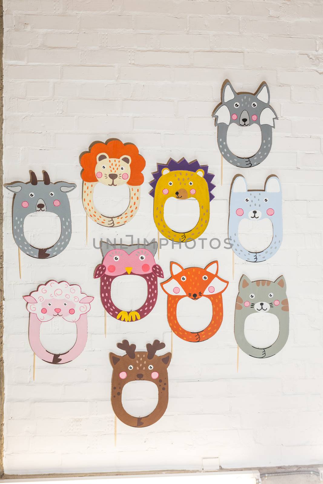 Set of cardboard masks on a white brick wall. Consept card.