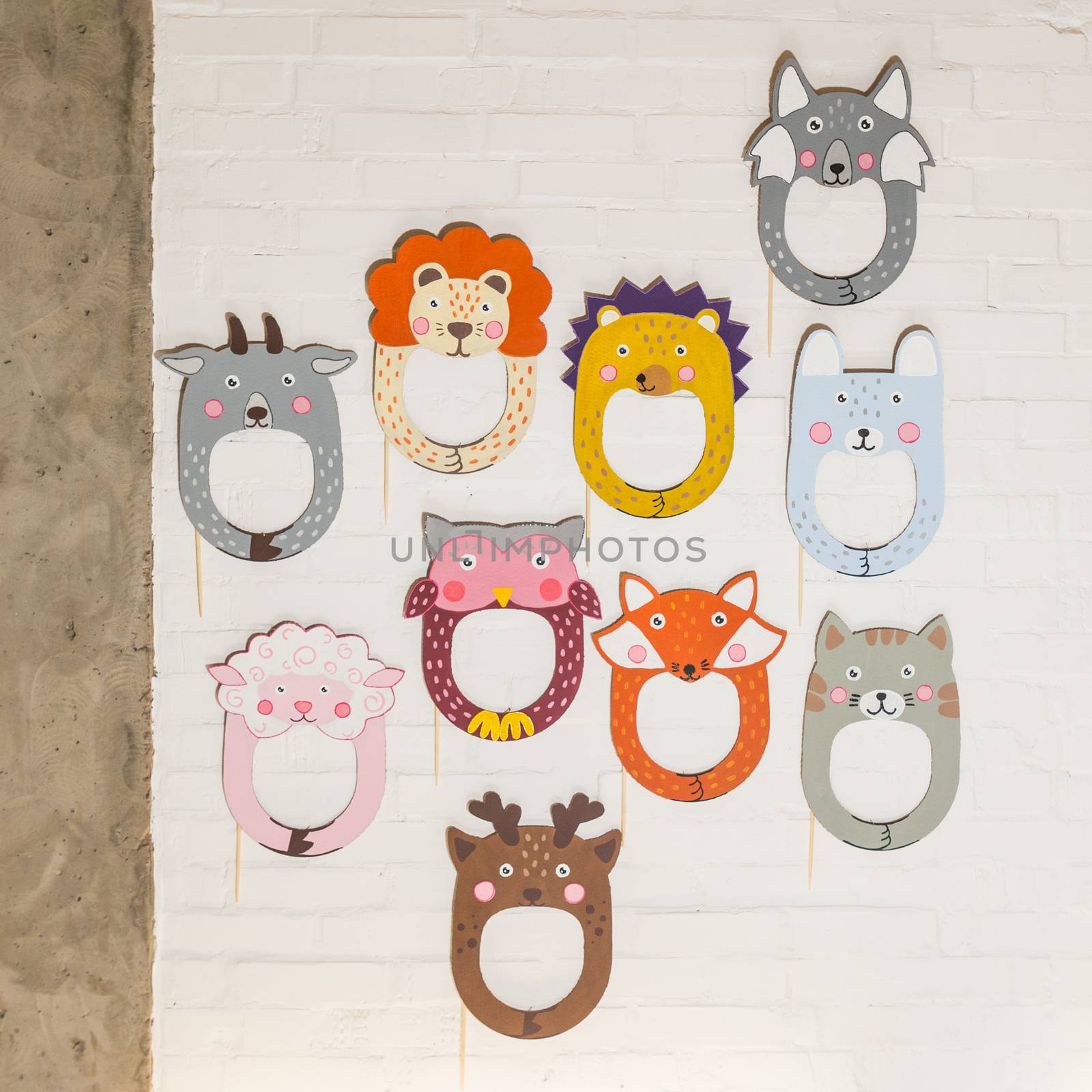 Set of cardboard masks on a white brick wall. Consept card.