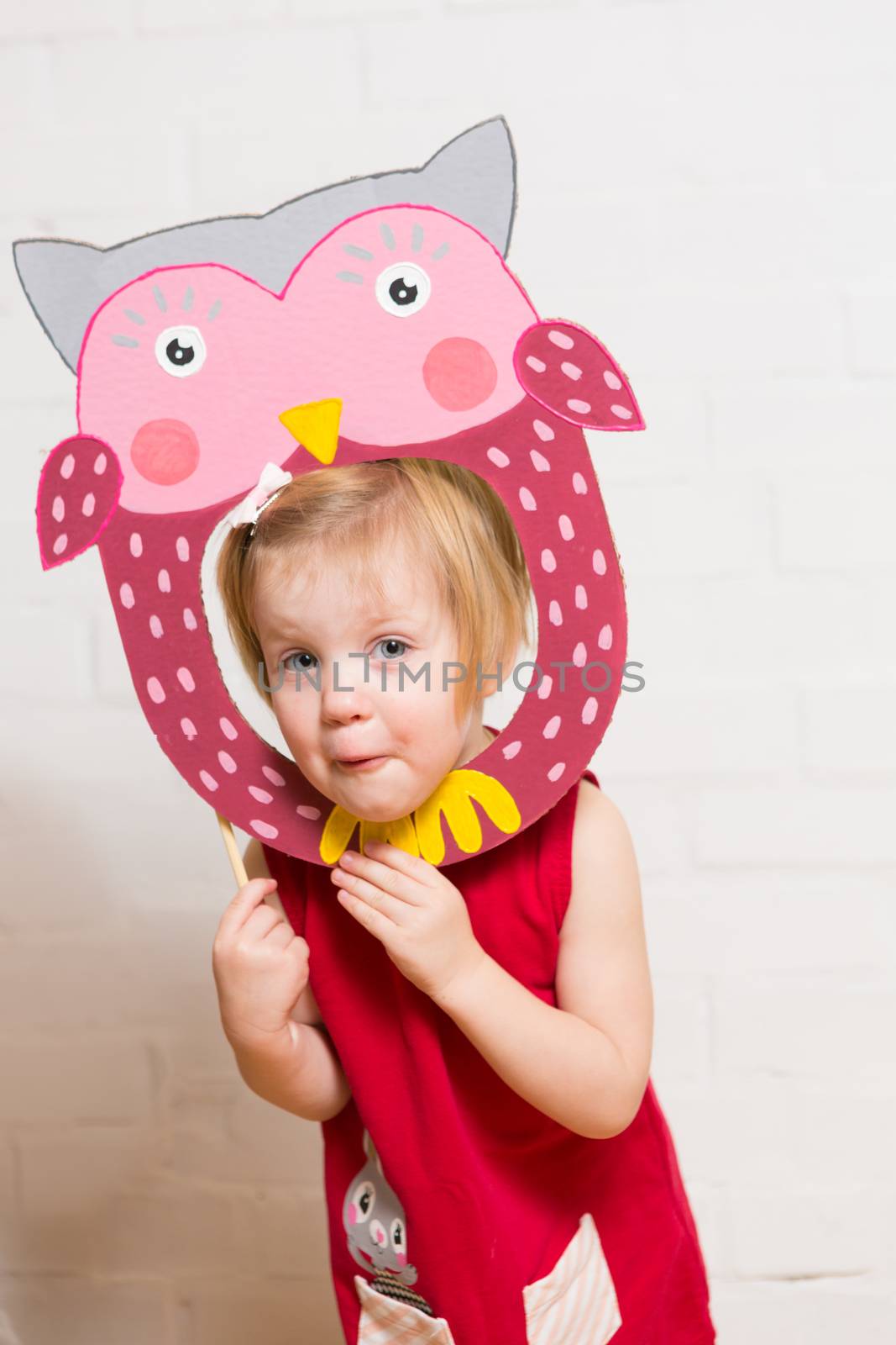 Little girls holding owl mask on white background by sarymsakov