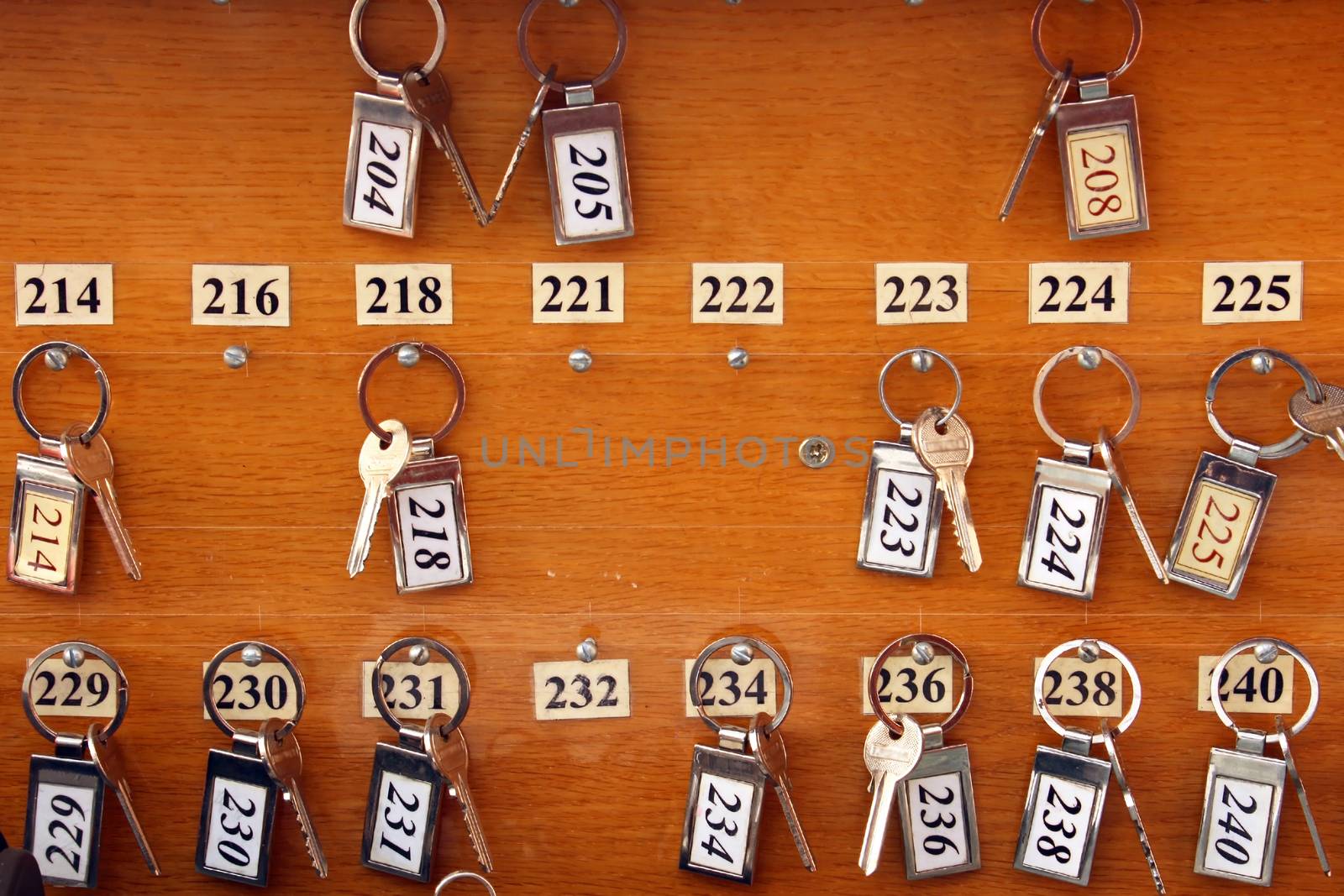 Several hotel keys on wooden board