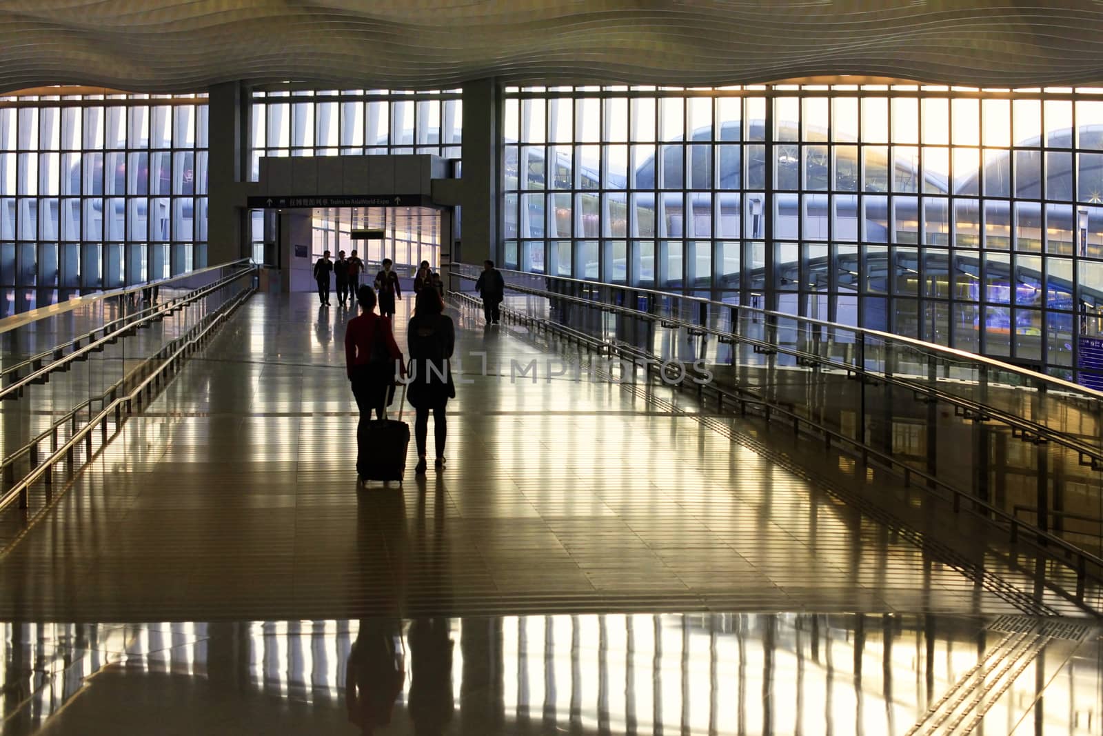 HONG KONG, S.A.R., CHINA - JENUARY 29, 2014: Passengers in the airport main lobby on Jenuary 29, 2014 in Hong Kong, China. The Hong Kong airport handles more than 70 million passengers per year.