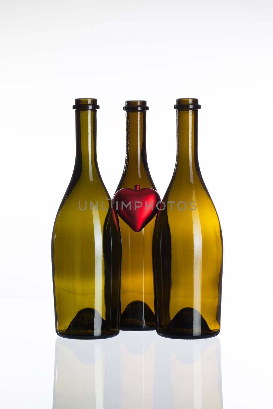 Empty bottles of wine and love symbol by CaptureLight