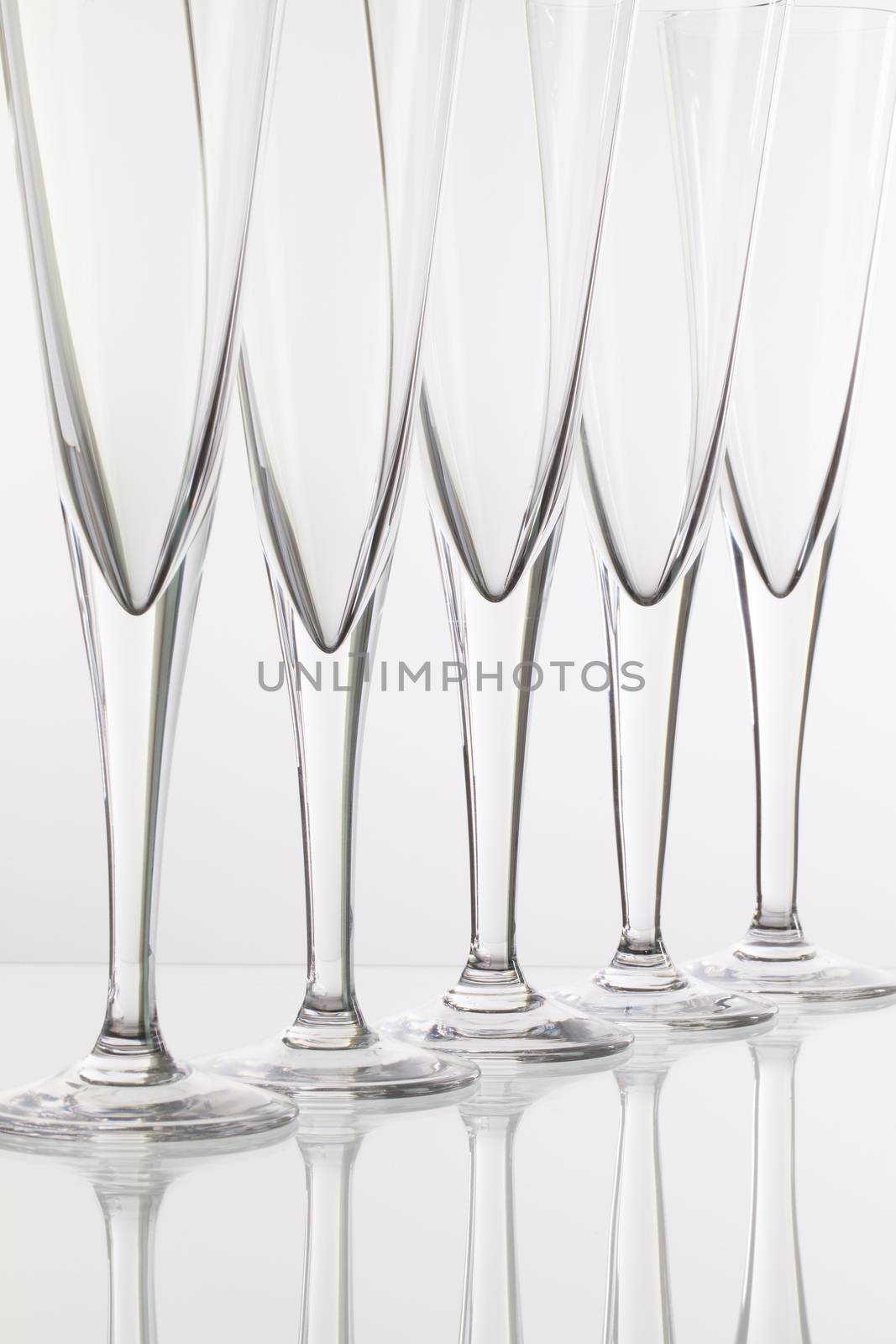 Empty champagne glasses on the glass desk