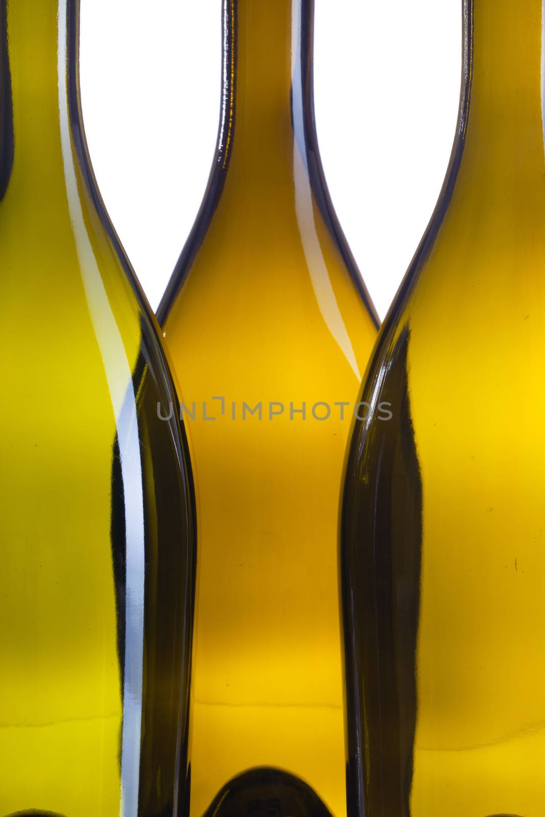 Detail of three empty wine bottles on a white background