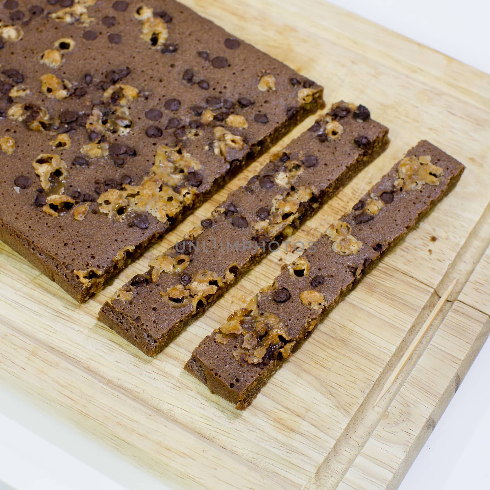 Cutting homemade brownies on wooden background