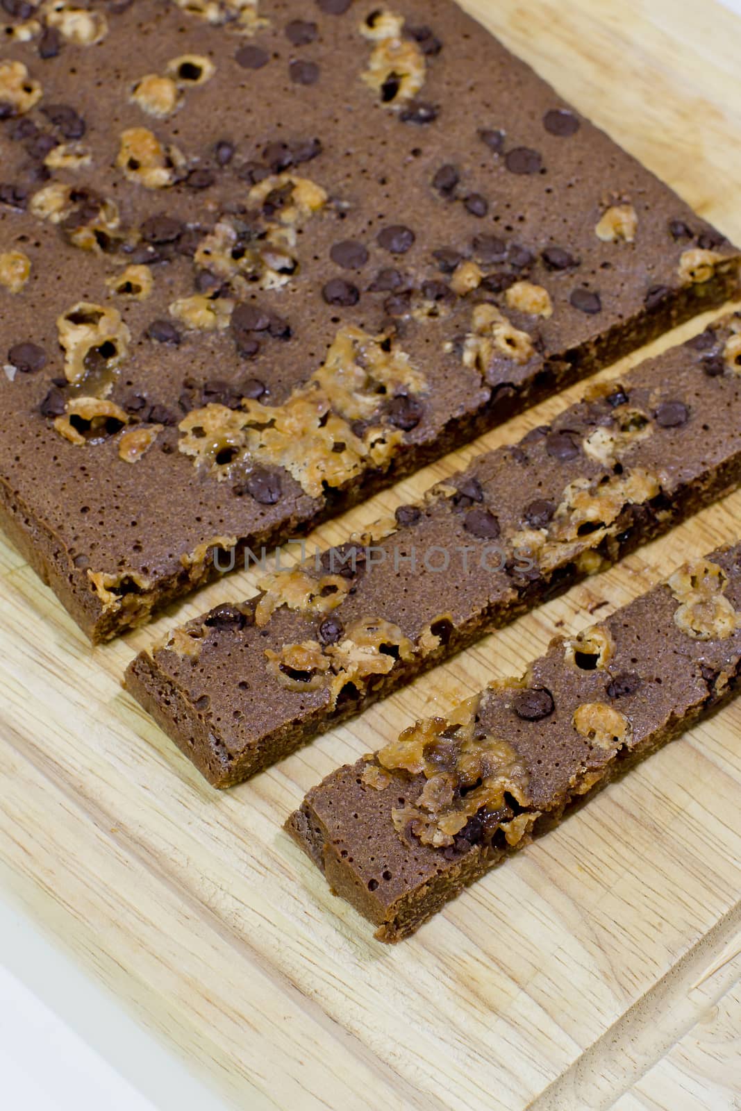 Cutting homemade brownies on wooden background