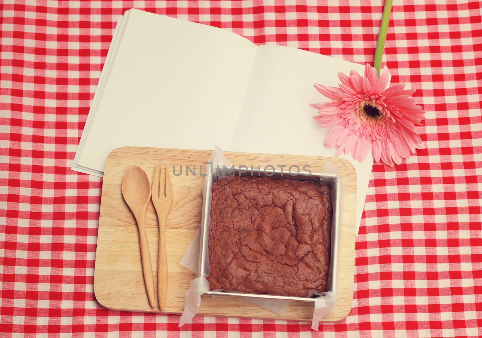 Homemade brownie on blank notebook with retro filter effect by nuchylee