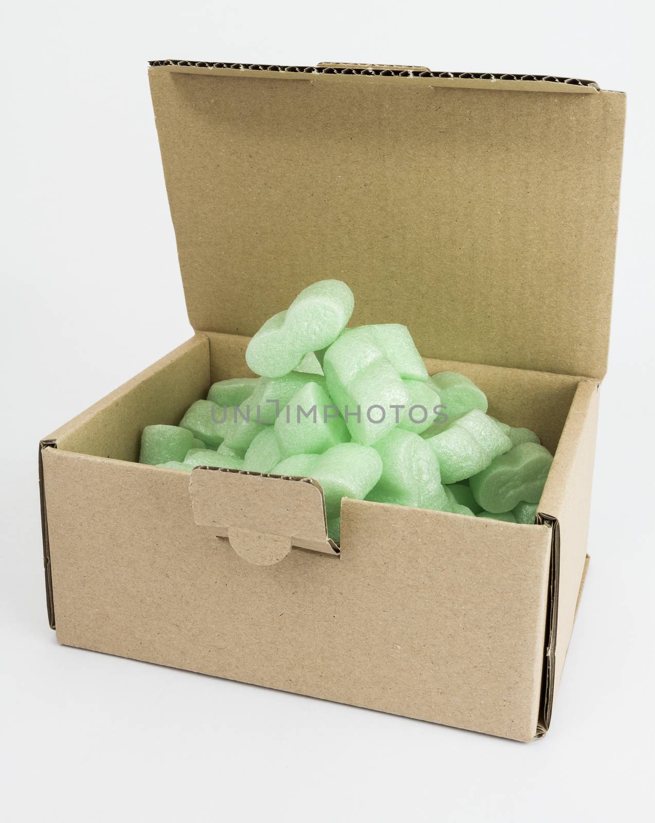 open packaging box with green foam on neutral grey background