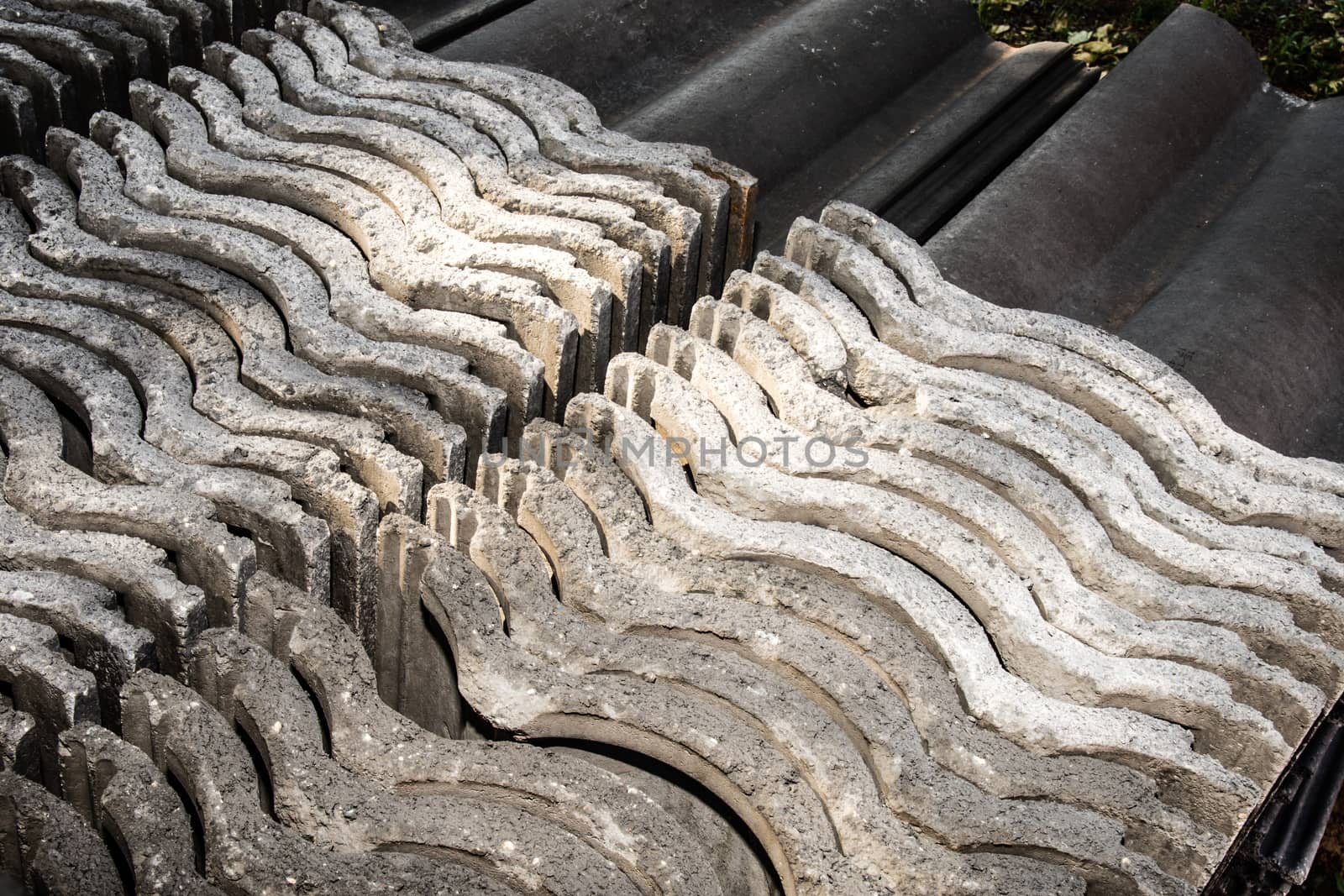 Roof tiles stacked needly to be used in new building project.