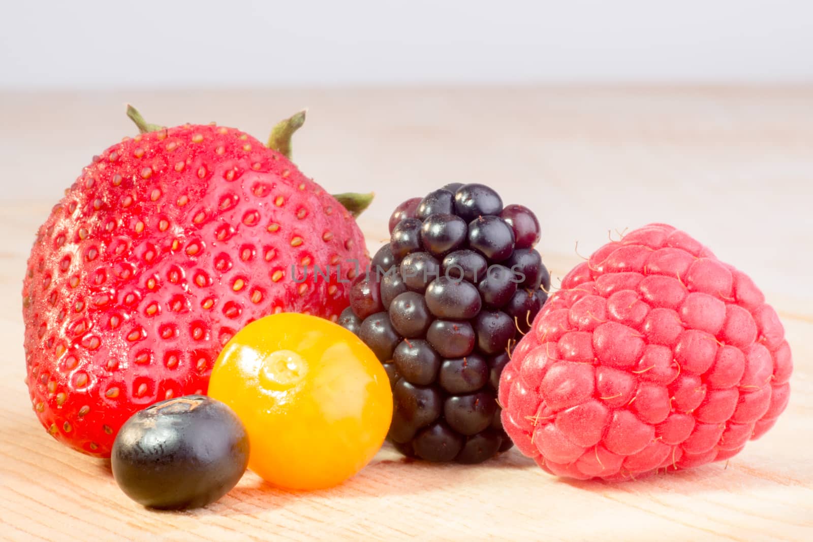 Close up of four different berries, all fresh and in Season.