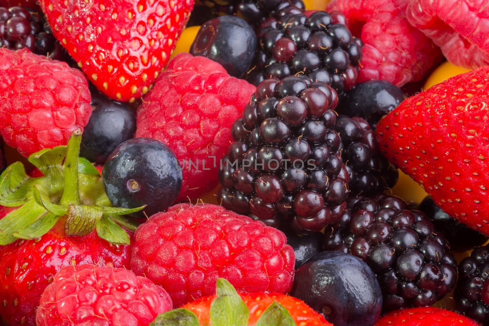 Up Close view of fresh berries of different types, all mixed together.