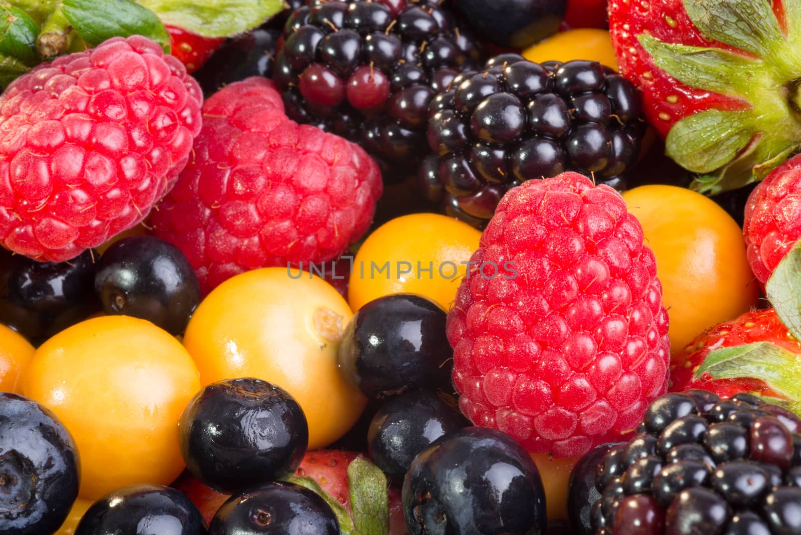 Up Close view of fresh berries of different types, all mixed together.