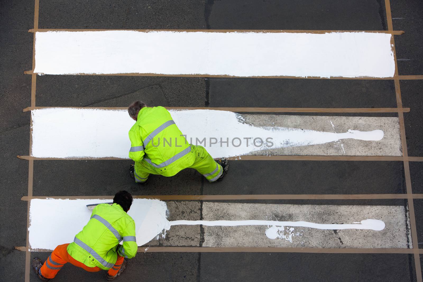 workers painting crosswalk by courtyardpix