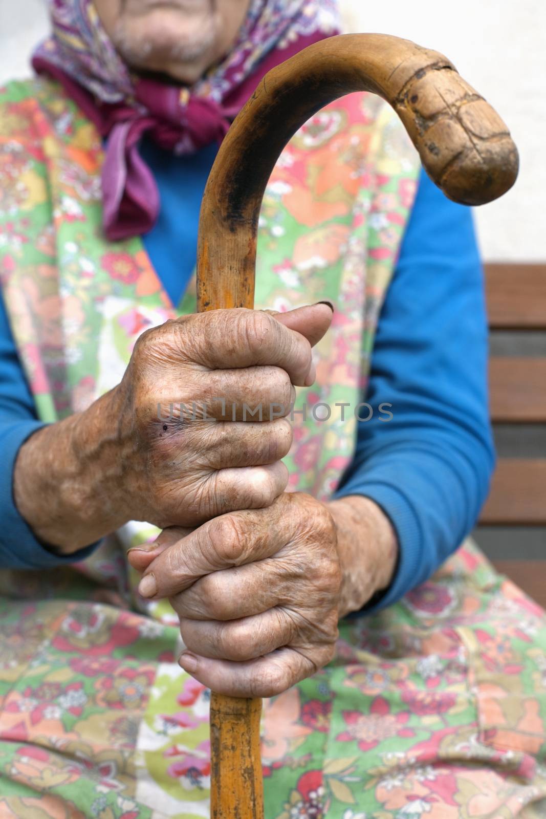 hands of an old woman with a cane by courtyardpix