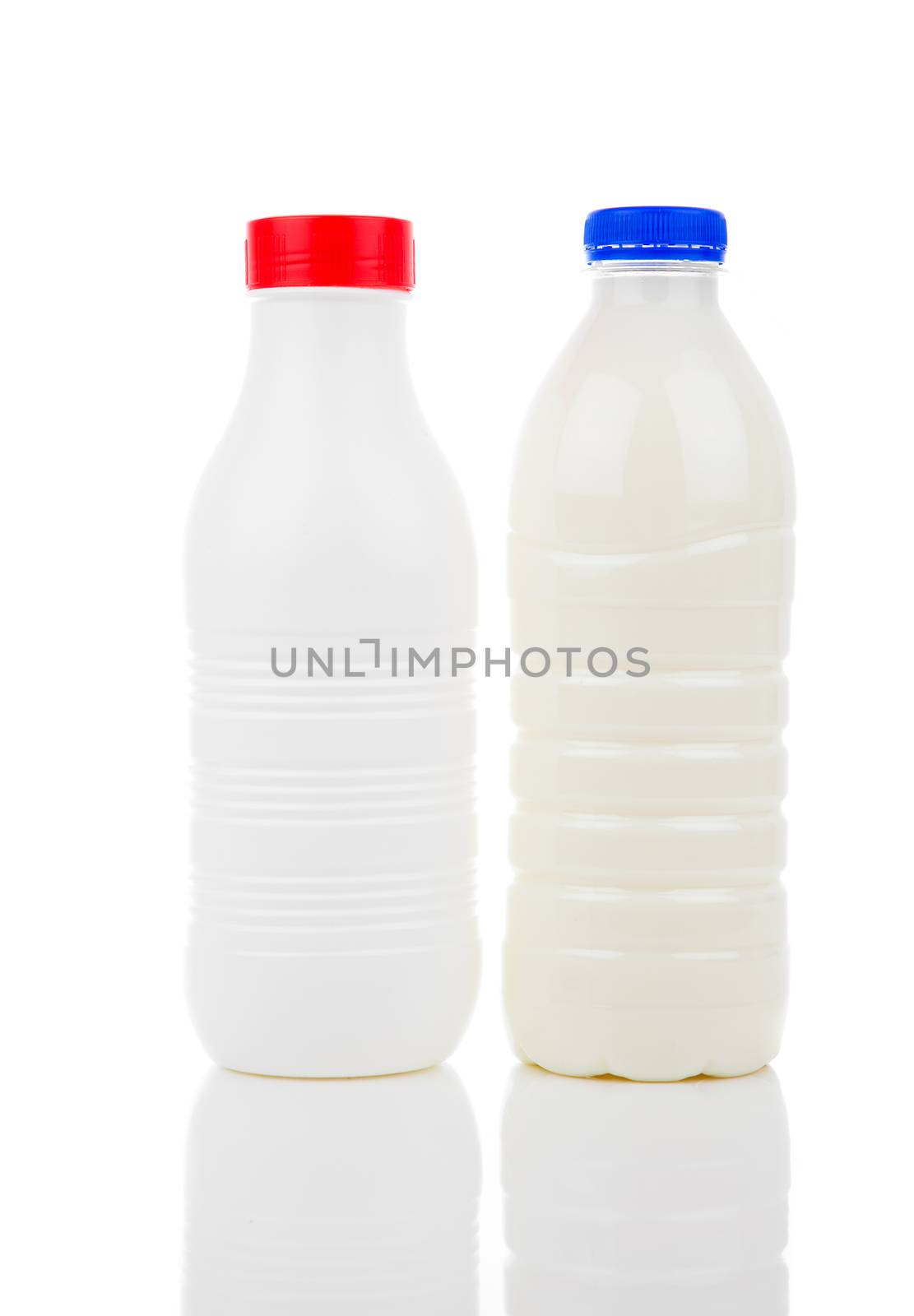 two bottles of milk isolated on white background by motorolka